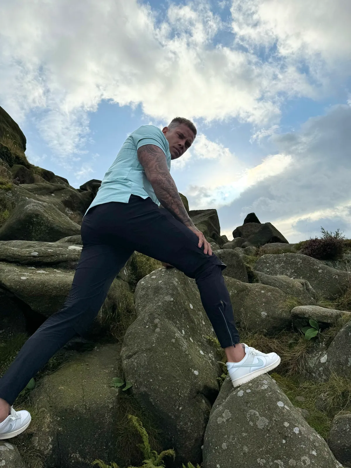 Athlete climbing rocks in Keep Pushing gear