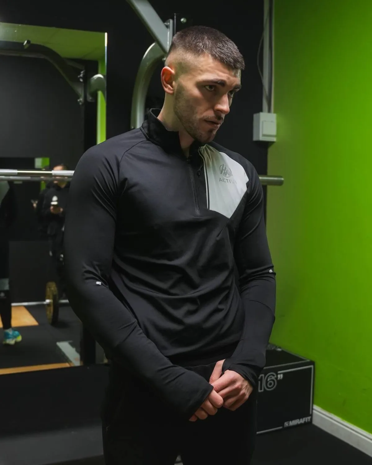 Man wearing the Keep Pushing Active quarter zip top in the gym